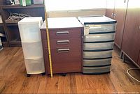 Front view of all three storage units side by side with measuring tape for scale