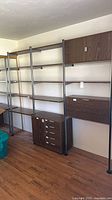 entire shelving unit showing uprights, shelves, and storage modules