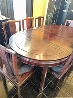 Dining table with chairs arranged around it