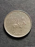 reverse showing mounted police design with dates 1873 1973 and CANADA 25 CENTS legend