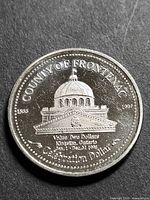 Obverse showing Kingston City Hall and denomination details
