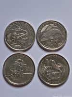 Obverse sides of four Canadian commemorative quarters