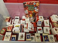 Tote filled with numerous Hallmark Keepsake ornament boxes and collector binder