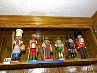 Shelf view of all six nutcrackers side by side