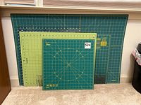 All four cutting mats and acrylic rulers stacked against wall