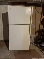 Front view of closed refrigerator showing Maytag badge and handles