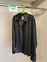 Full view of Issey Miyake blouse hanging on hanger