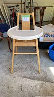 Front view of wooden high chair with tray attached