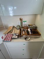all items on counter including linens, utensils on board, bowls