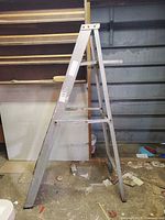 Full side view of folded A-frame aluminum stepladder
