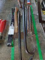 Overview of pry bars, wood handle, red-handled chisels