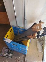 Crate with multiple hand saws visible