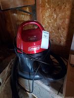 Front angled view showing Coleman branding, hose attached, overall appearance