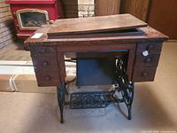 Front view of Domestic treadle sewing machine cabinet showing six drawers and missing top panel