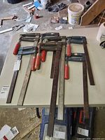 All seven bar clamps laid out to show overall condition and size variety