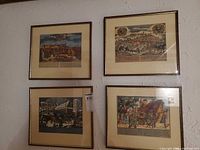 Four framed prints hanging on wall