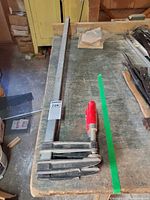 Three Gross Stabil F-style bar clamps laid on workbench