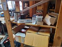 Shelf with multiple boxes and tubs of nails and screws