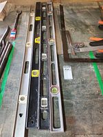 Four box levels laid side by side showing full length and vials