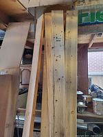 Front view of mixed lumber showing pine boards, hardwood board, plywood panel