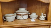All four speckled stoneware pieces on shelf