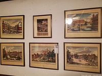 All six framed prints displayed together on wall
