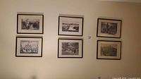 Six framed prints displayed on wall