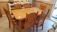 Dining table with six chairs around it