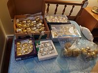 Overview of assorted boxed and loose ornaments on bed