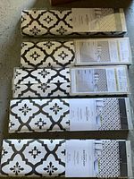 Five boxed Allen + Roth backsplash rolls laid out showing pattern and packaging