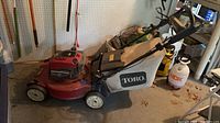 Full side view showing mower, bag, handle, wheels