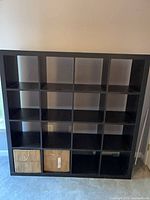 Front view of black 16-cube bookcase