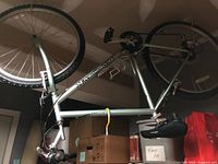 Full view of upside-down Diamondback men’s mountain bike hanging from ceiling