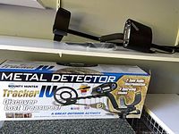 Box showing Bounty Hunter Tracker IV branding next to detector components on shelf