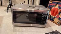 Front view of Sharp Carousel microwave showing door, keypad, display, stainless frame