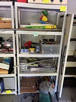 Front view of two shelving units loaded with miscellaneous items