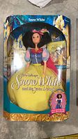 Front view of boxed Snow White Barbie doll