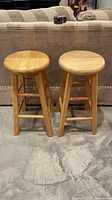Front view of both matching wooden stools