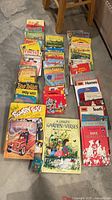 Group of approximately 50 vintage children’s books laid out in rows