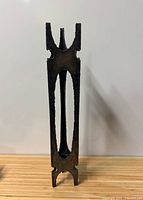 Full view of the brutalist metal stand showing overall form