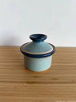 Side view of ceramic egg maker showing body and lid