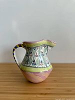 Left profile of ceramic creamer pitcher showing Bearded Iris band and swirl base