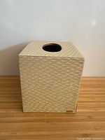 front view showing square tissue box cover, texture, brand plaque