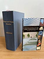 Both hardcover books standing upright: History of Placer and Nevada Counties (cloth) and Official Guide to the Smithsonian (glossy)