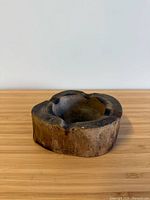 Top angled view of wooden ashtray showing bowl depth and exterior grain