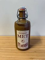 Front view of stoneware bottle showing label and closure