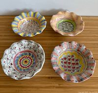 Top view of all four MacKenzie-Childs Stoke Gabriel fluted bowls