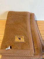 Folded blanket showing Camel 100% patch