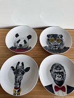 Front view of four plates showing animal designs