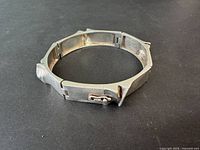 Oblique view showing sculptural exterior and clasp